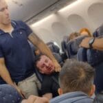 A passenger on board a flight from flight from Brazil to Panama was  severely beaten after he tried to open the plane's emergency door in mid-flight