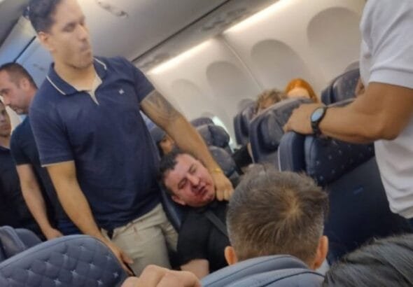 A passenger on board a flight from flight from Brazil to Panama was  severely beaten after he tried to open the plane's emergency door in mid-flight